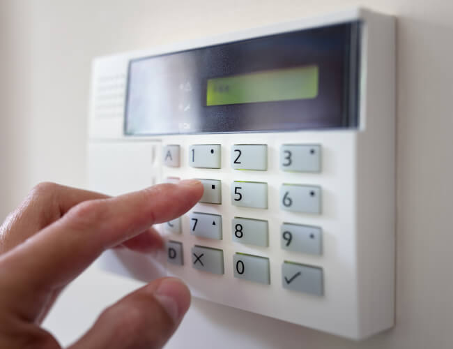 Commercial alarm system keypad being armed in a Dallas business
