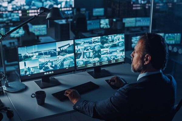 Operator watching Frisco business video surveillance systems on screens