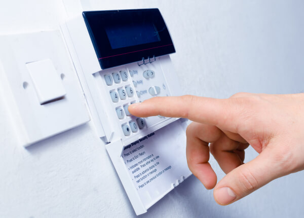 Programming a wall-mounted home alarm keypad during a home installation