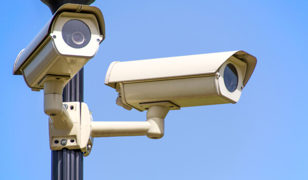 two-outdoor-commercial-security-cameras-pole-mounted-image Two outdoor commercial security cameras mounted on a pole